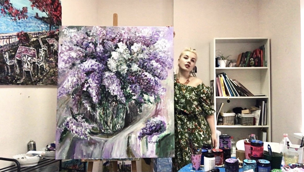 Marina Stognieva in her art studio creating Lush Lilac Bouquet